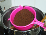 pour milk in a pot, sieve the cocoa powder into the milk, stir until combined